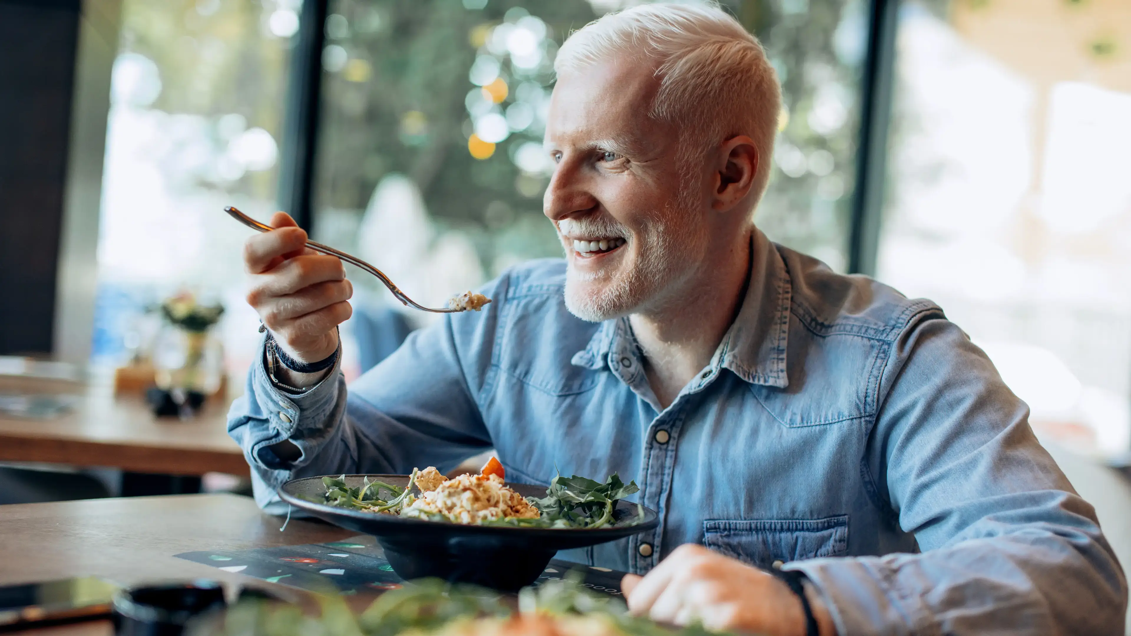 Adult enjoying a heart-healthy meal as part of cholesterol management