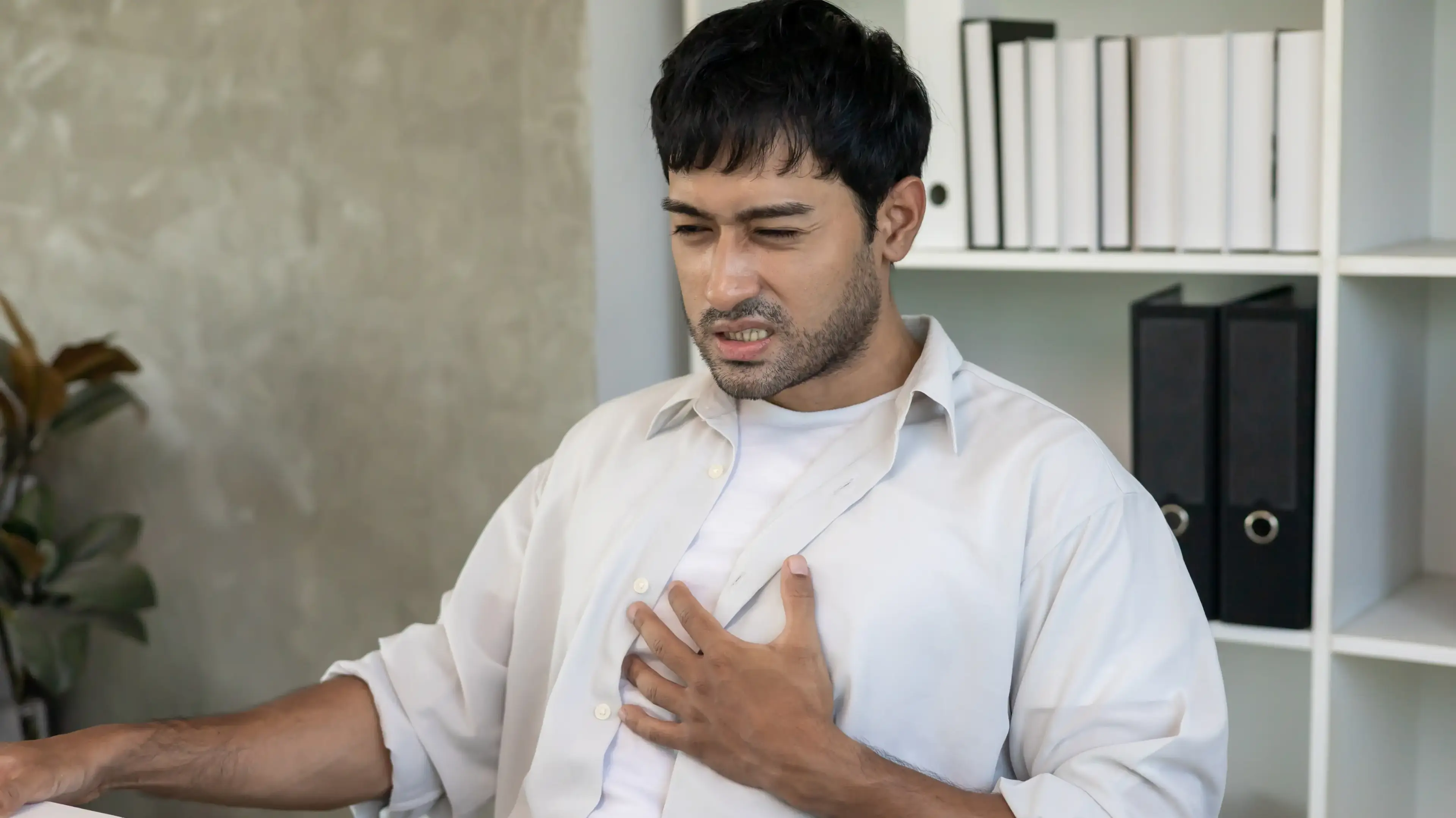 Adult experiencing chest discomfort from acid reflux